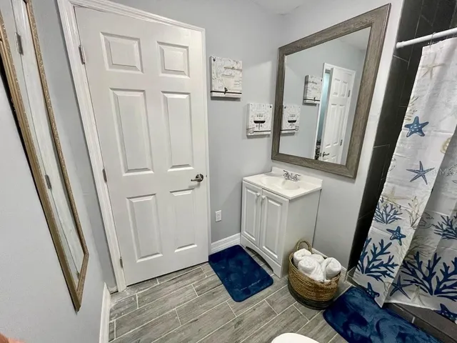 a view of living room with wooden floor and rug