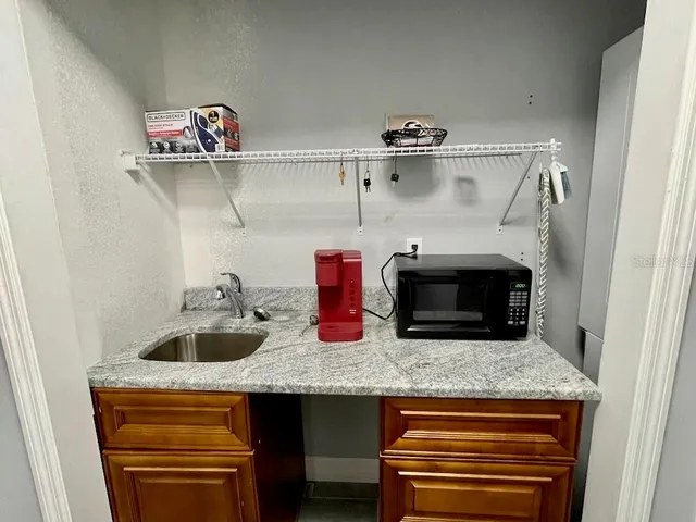 a kitchen with cabinets and appliances