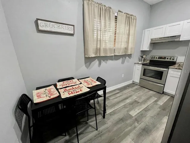 a view of a kitchen with workspace and wooden floor