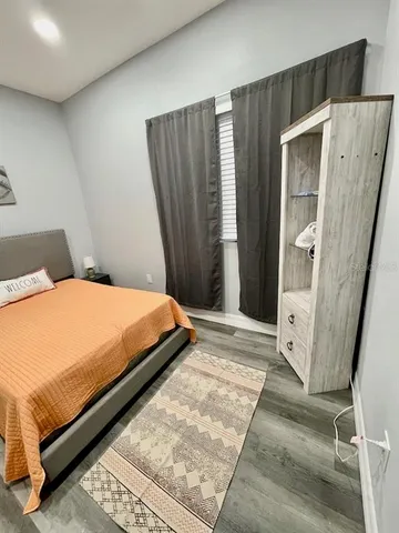 a bedroom with a bed and a mirror