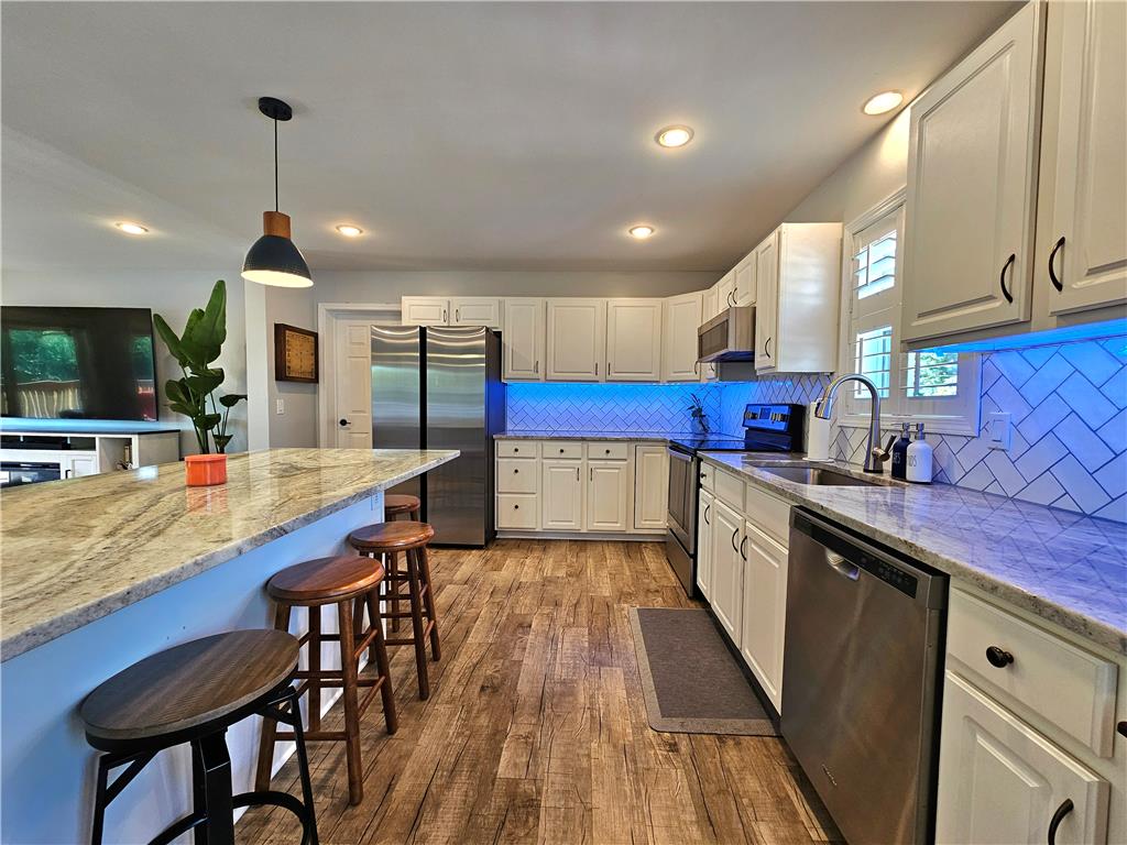190 Canal Road Easton, PA 18042 - Photo 4 of 39 a kitchen with stainless steel appliances granite countertop wooden cabinets a dining table and chairs