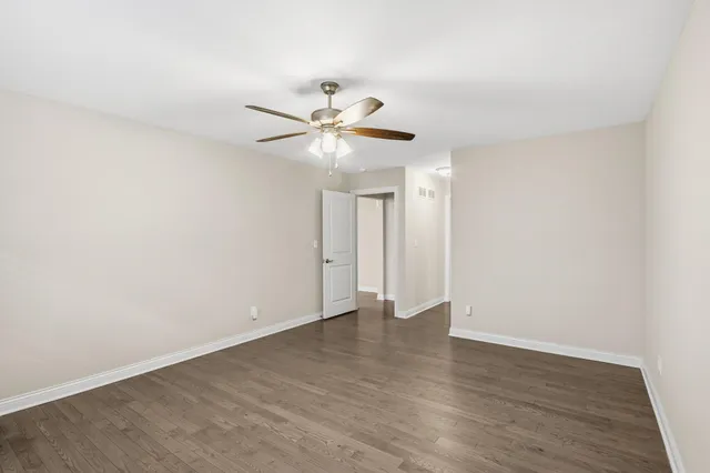 a view of an empty room with a fan