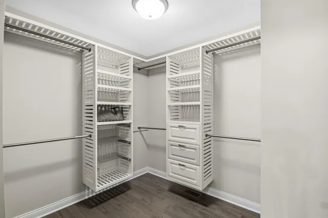 a view of walk in closet with empty racks