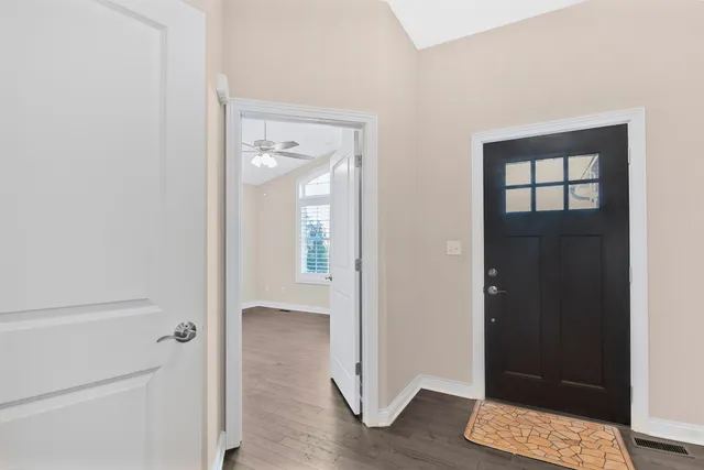 an entryway at a room with wooden floor