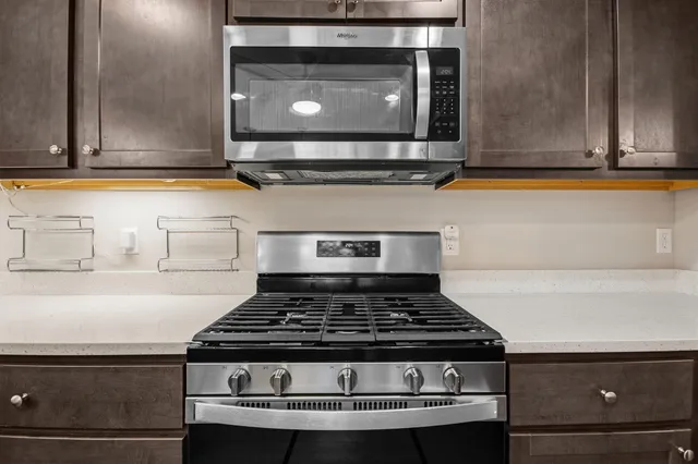 a stove top oven sitting inside of a kitchen