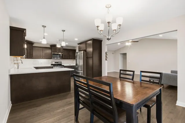 a kitchen with kitchen island a sink appliances and cabinets