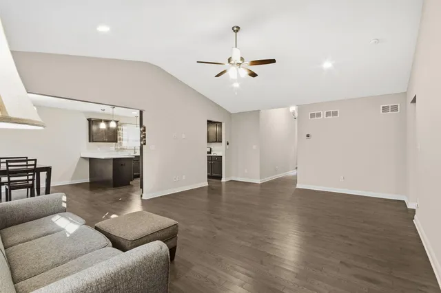 a living room with furniture and a ceiling fan