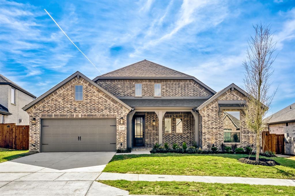 147 Derrett Lane Rhome, TX 76078 - Photo 1 of 28 View of front of home with a porch, brick siding, a garage, driveway, and roof with shingles