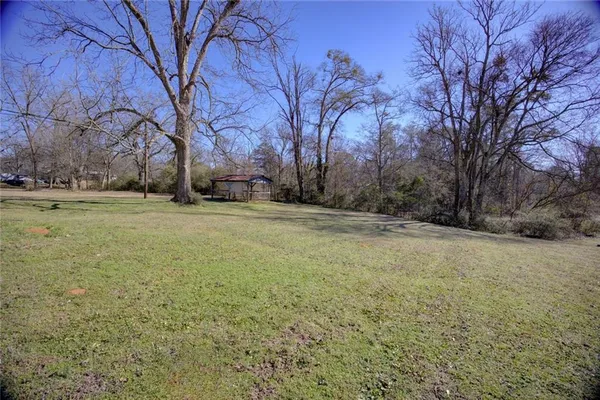 an empty room with wooden floor and entrance