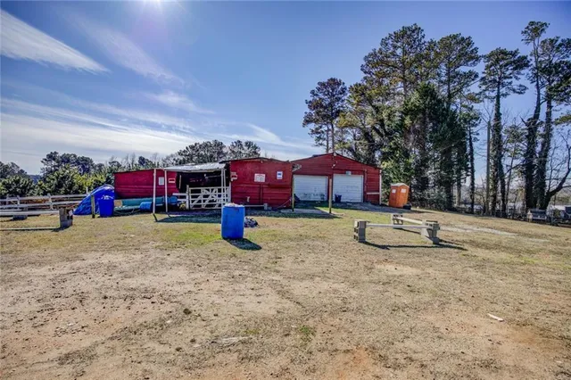 a view of a backyard with wooden fence