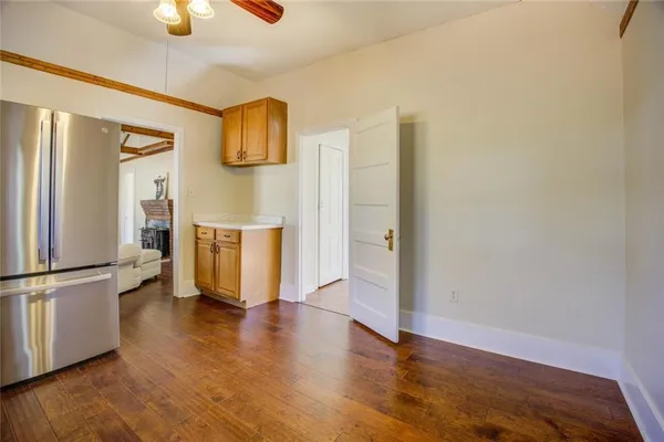 a kitchen with granite countertop a refrigerator and a stove top oven