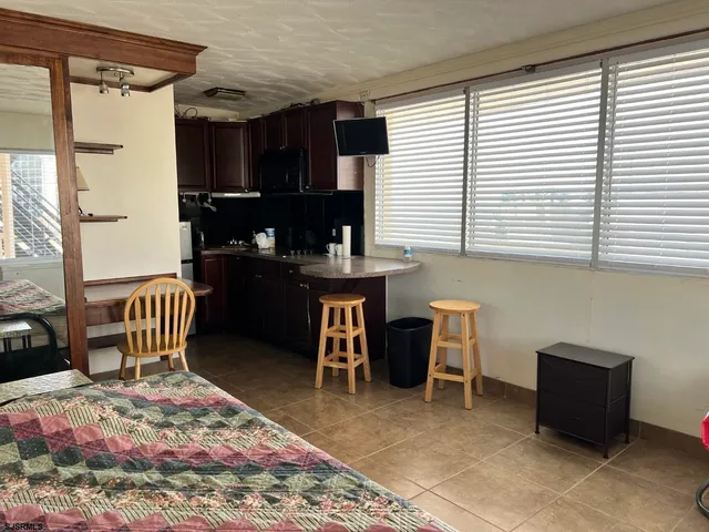a kitchen with a stove a refrigerator and a dining table
