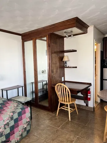 a bedroom with furniture and a window