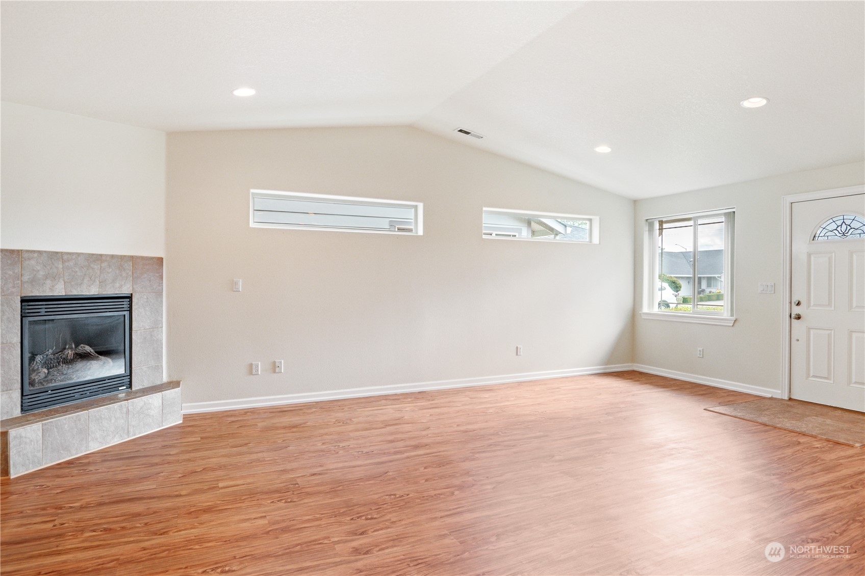 8 Willow Pointe Loop Longview, WA 98632 - Photo 5 of 29 an empty room with wooden floor fireplace and windows