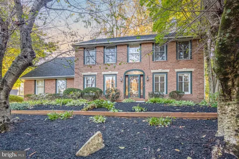 a front view of a house with a yard and potted plants