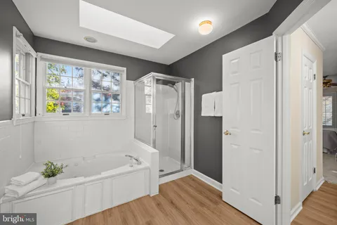 a white bath tub sitting in a bathroom next to a window
