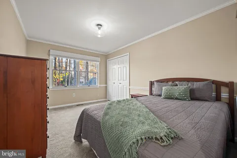 a spacious bedroom with a large bed and a large window
