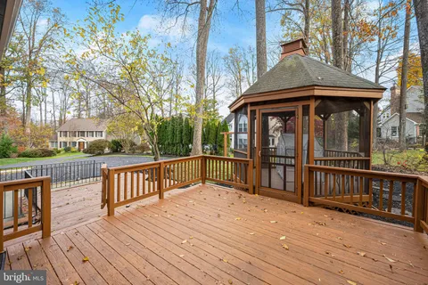 a view of a wooden deck with a yard
