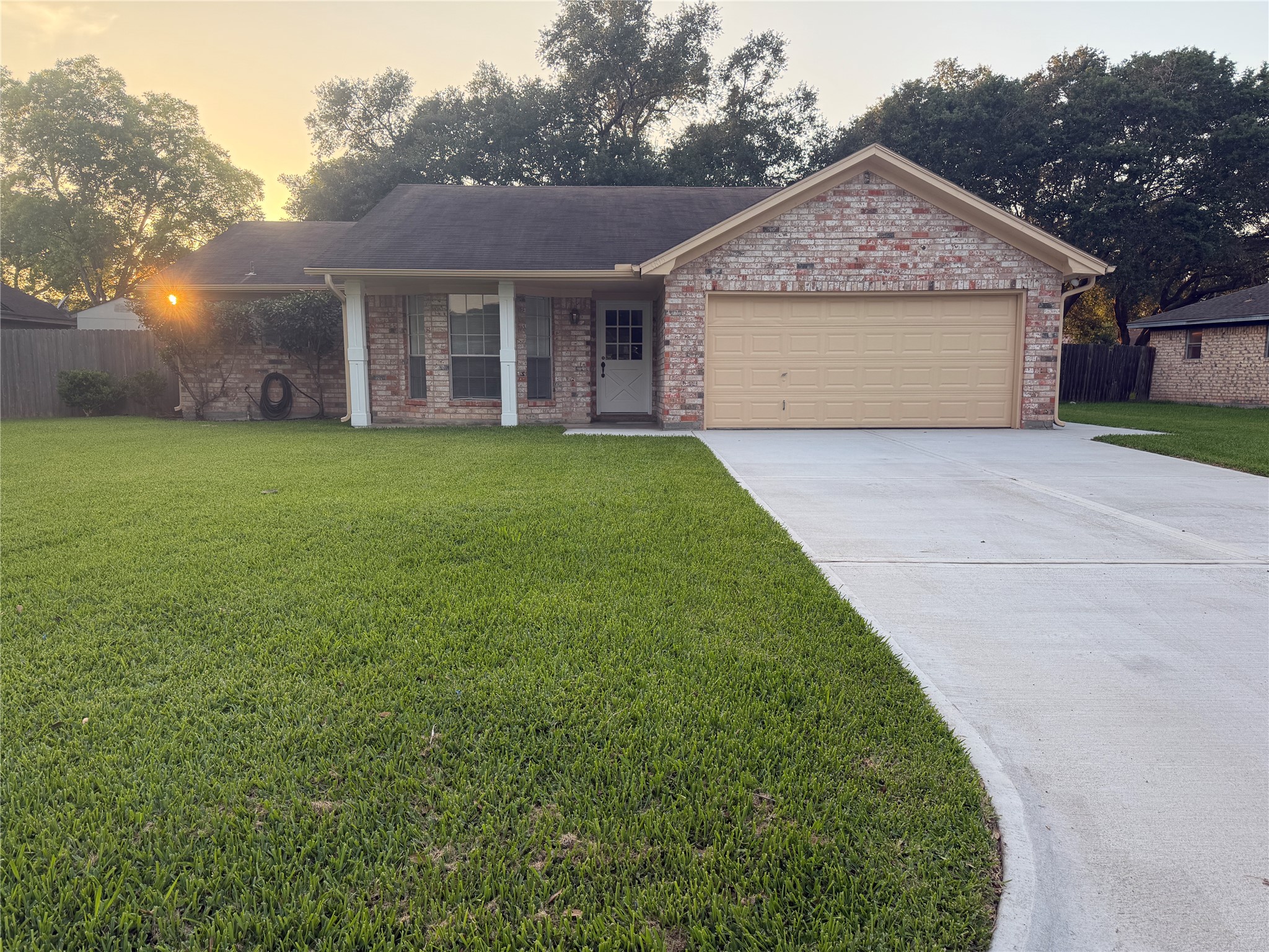 a front view of a house with a garden and yard