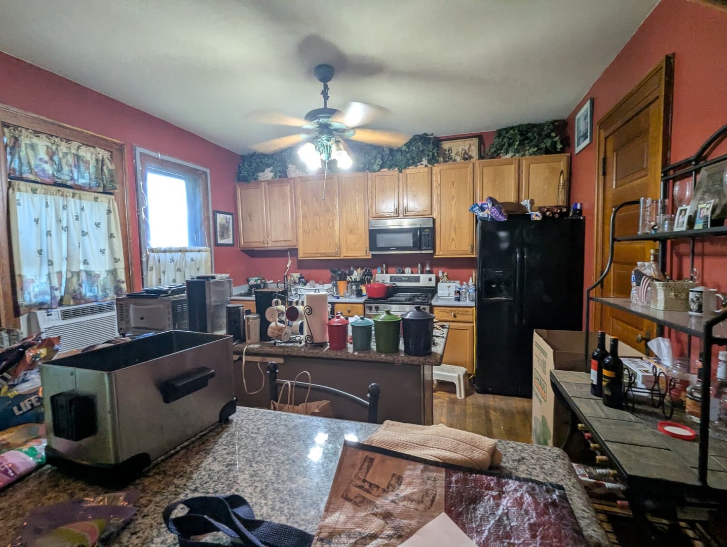 1635 20th Street Rock Island, IL 61201 - Photo 14 of 25 a kitchen with stainless steel appliances kitchen island granite countertop a refrigerator and a stove top oven