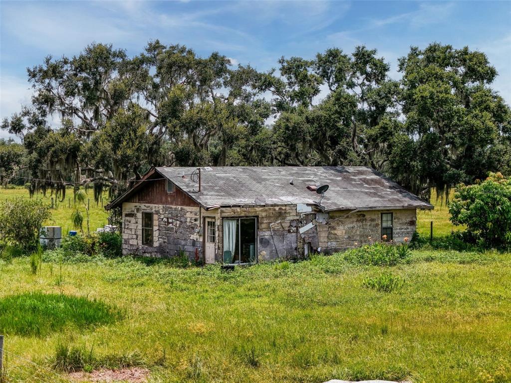 12950 River Road Myakka City, FL 34251 - Photo 2 of 32 a view of a house with a big yard plants and large trees