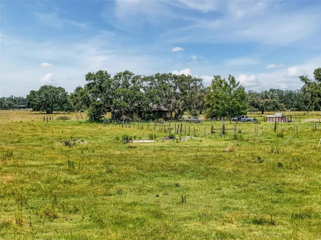 a swimming pool with an outdoor seating and a lake view