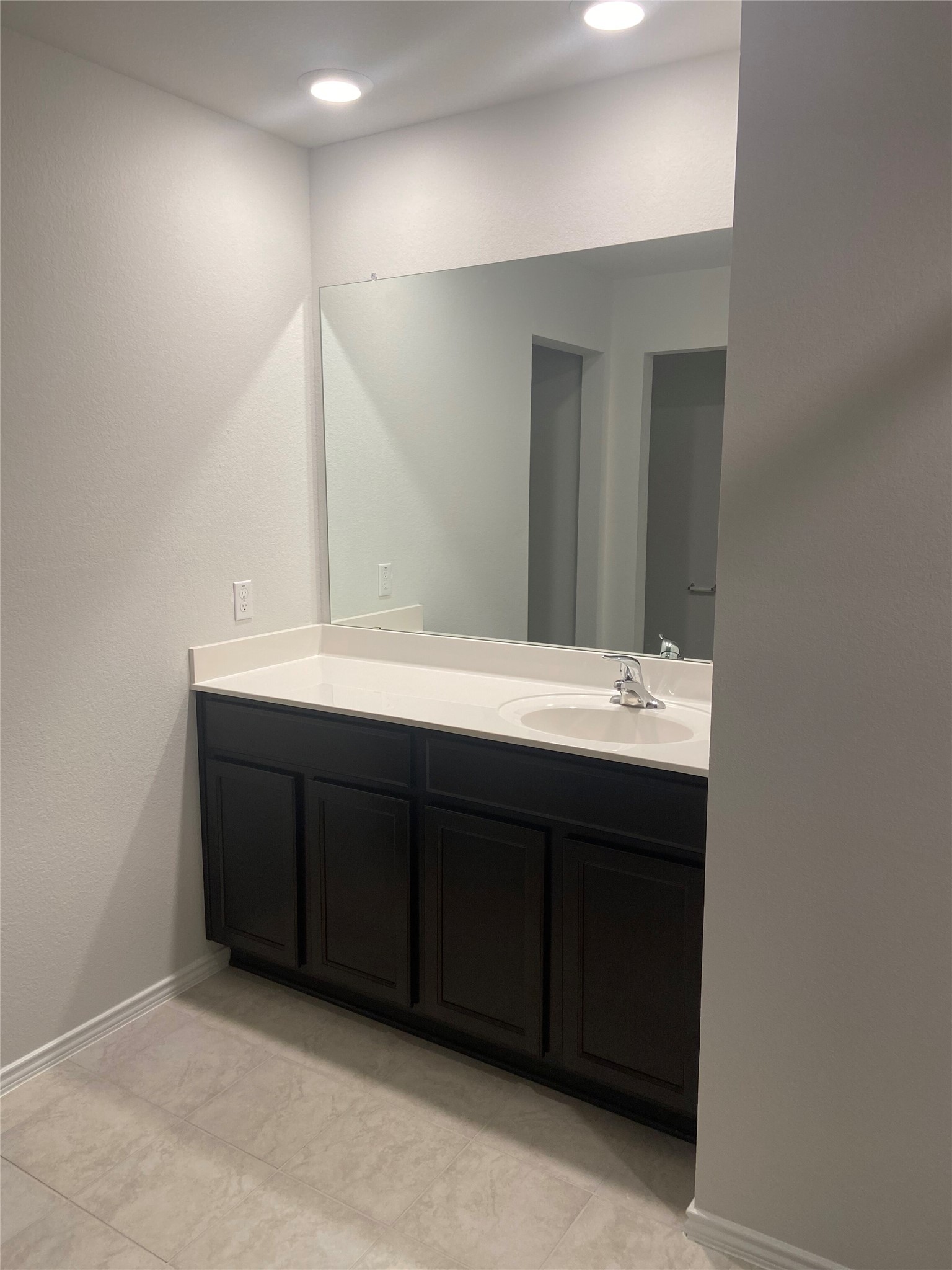 516 Taggart Trail Jarrell, TX 76537 - Photo 7 of 10 A sleek dark wood vanity with a single basin sink and generous counter space.