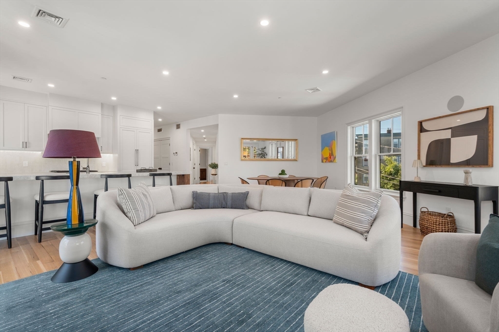 69 Williams Street, Unit 202 Boston, MA 02130 - Photo 2 of 22 a living room with furniture a wooden floor and a large window