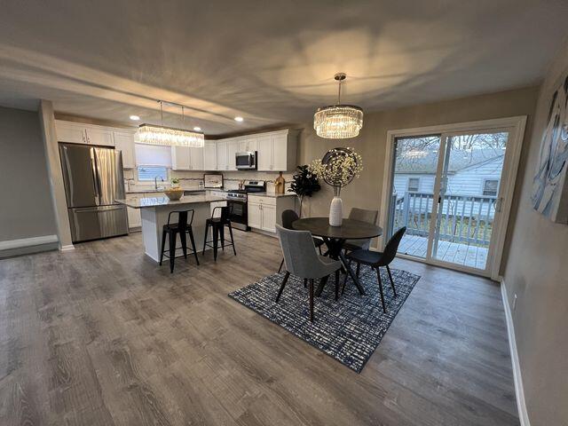 5174 Independence Avenue Portage, IN 46368 - Photo 7 of 26 a view of a dining room with furniture window and wooden floor