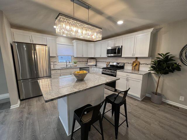 5174 Independence Avenue Portage, IN 46368 - Photo 9 of 26 a kitchen with a center island and stainless steel appliances