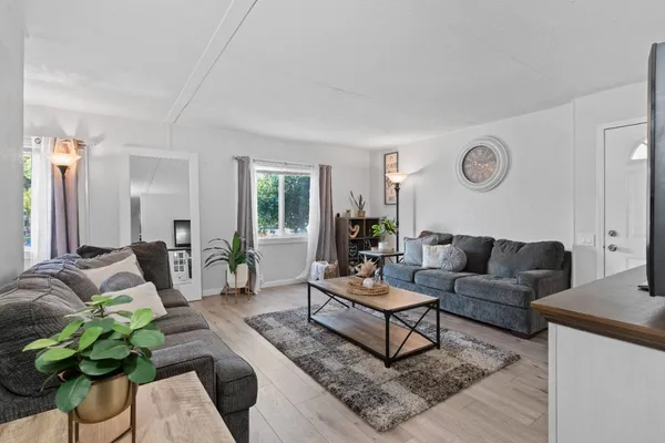 a living room with furniture rug and window