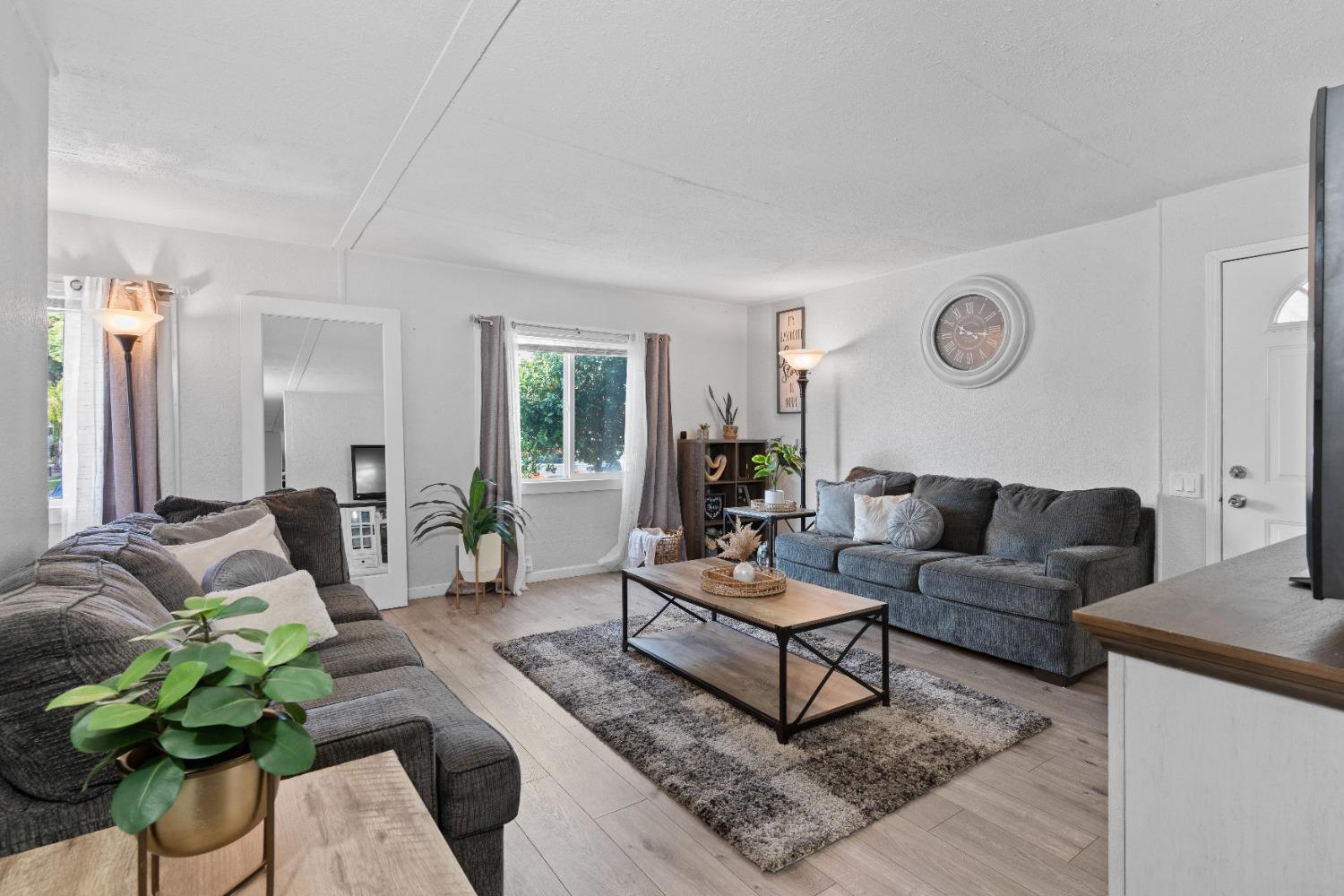 a living room with furniture rug and window