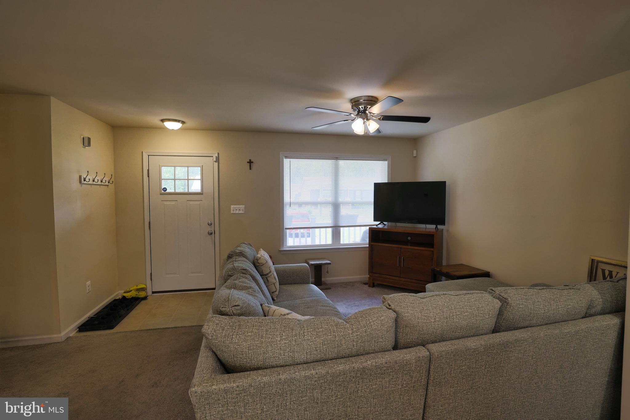 48 Rustic Lane Colonial Beach, VA 22443 - Photo 22 of 47 a living room with furniture a ceiling fan and a window