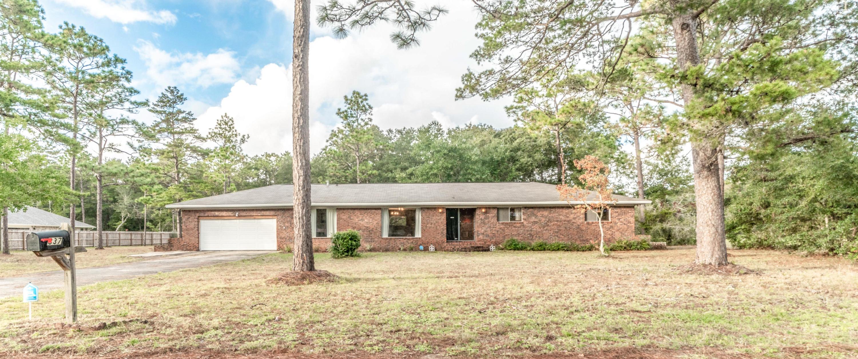837 Cardinal Street Fort Walton Beach, FL 32547 - Photo 1 of 24 a front view of a house with a yard