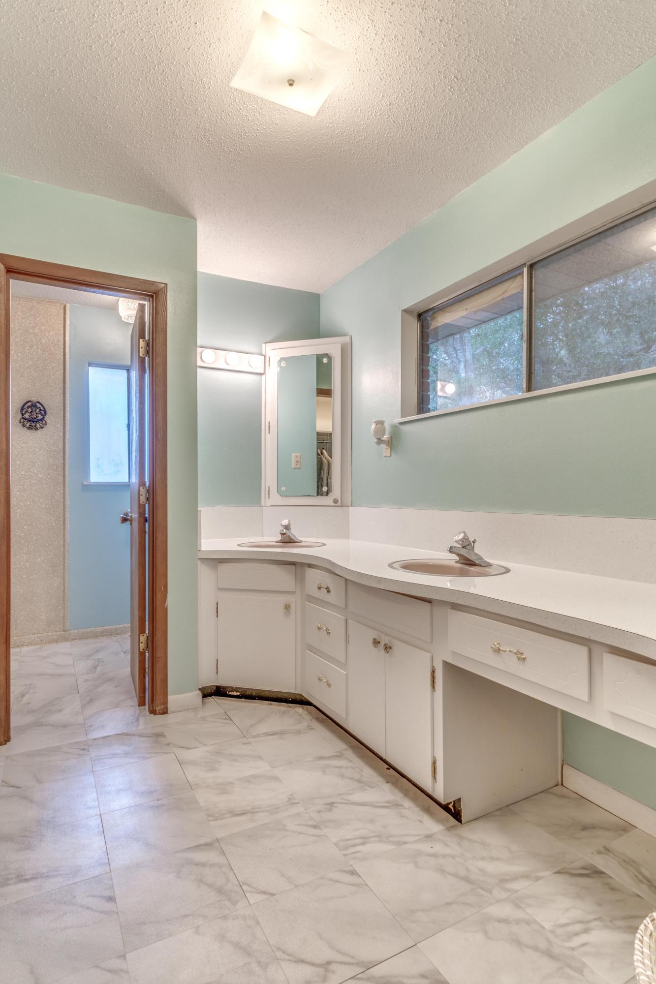 837 Cardinal Street Fort Walton Beach, FL 32547 - Photo 13 of 24 a large bathroom with a double vanity sink a mirror and a bathtub
