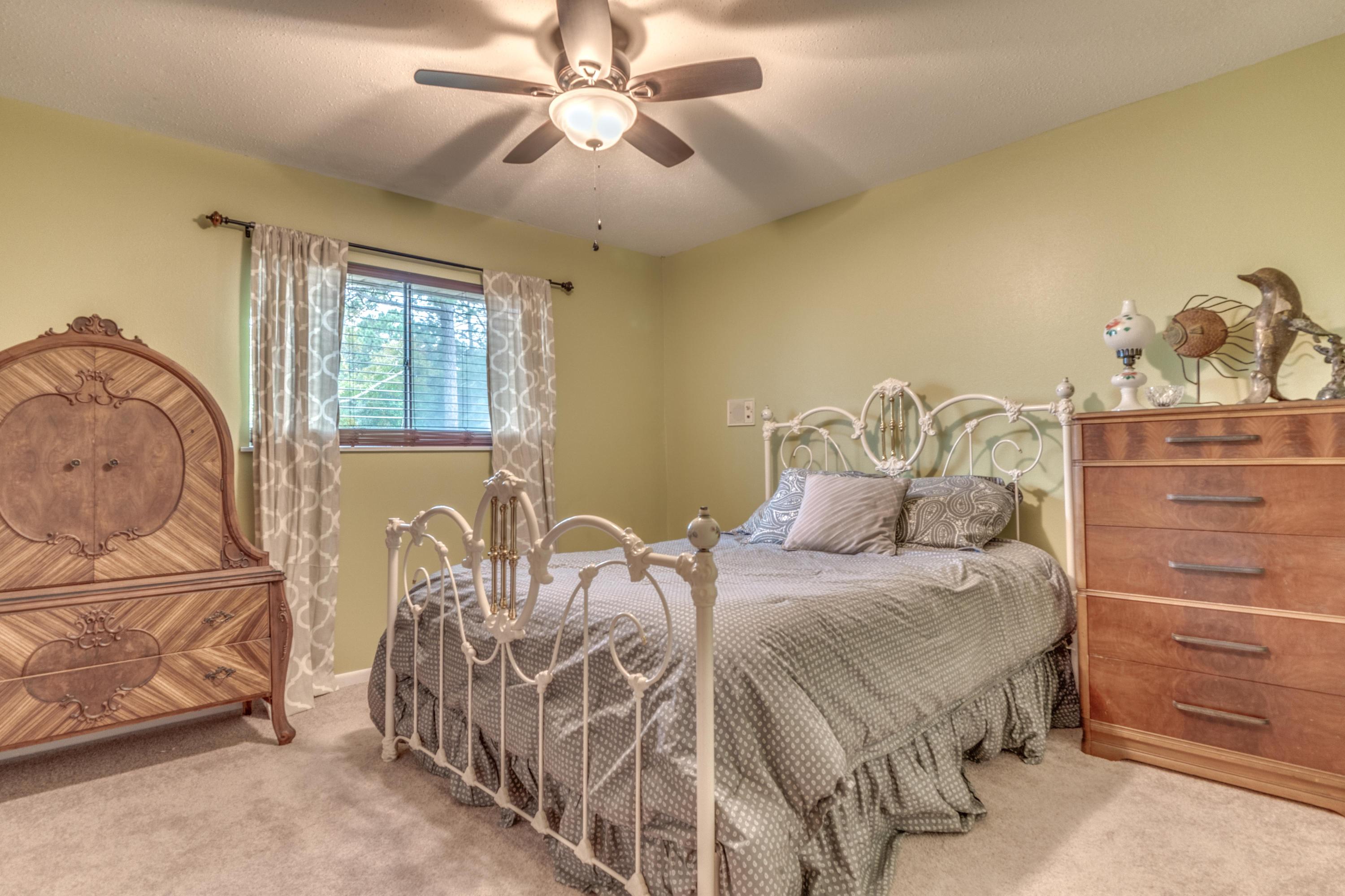 837 Cardinal Street Fort Walton Beach, FL 32547 - Photo 16 of 24 a bedroom with a bed and wooden floor
