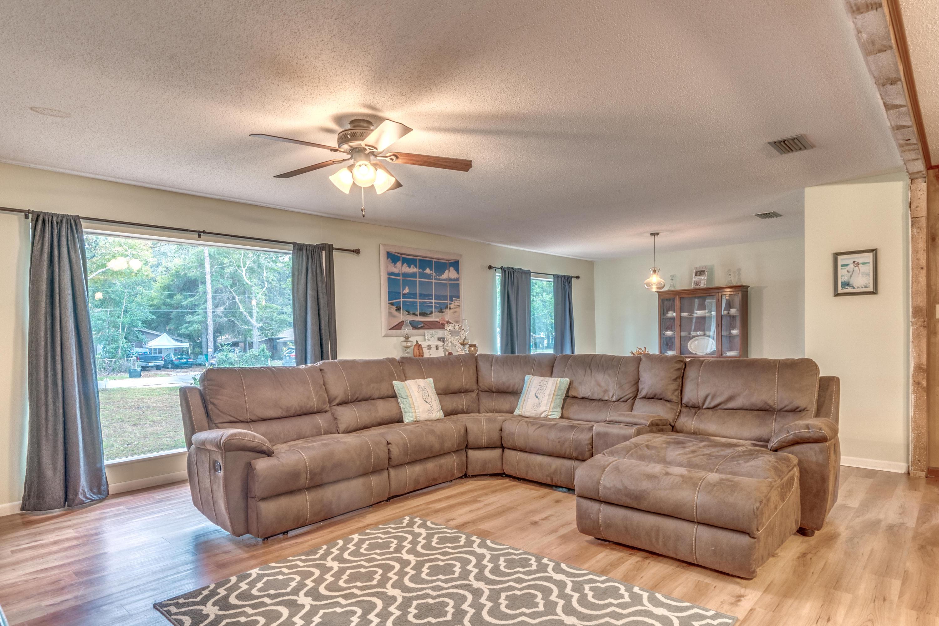 837 Cardinal Street Fort Walton Beach, FL 32547 - Photo 4 of 24 a living room with furniture and a large window