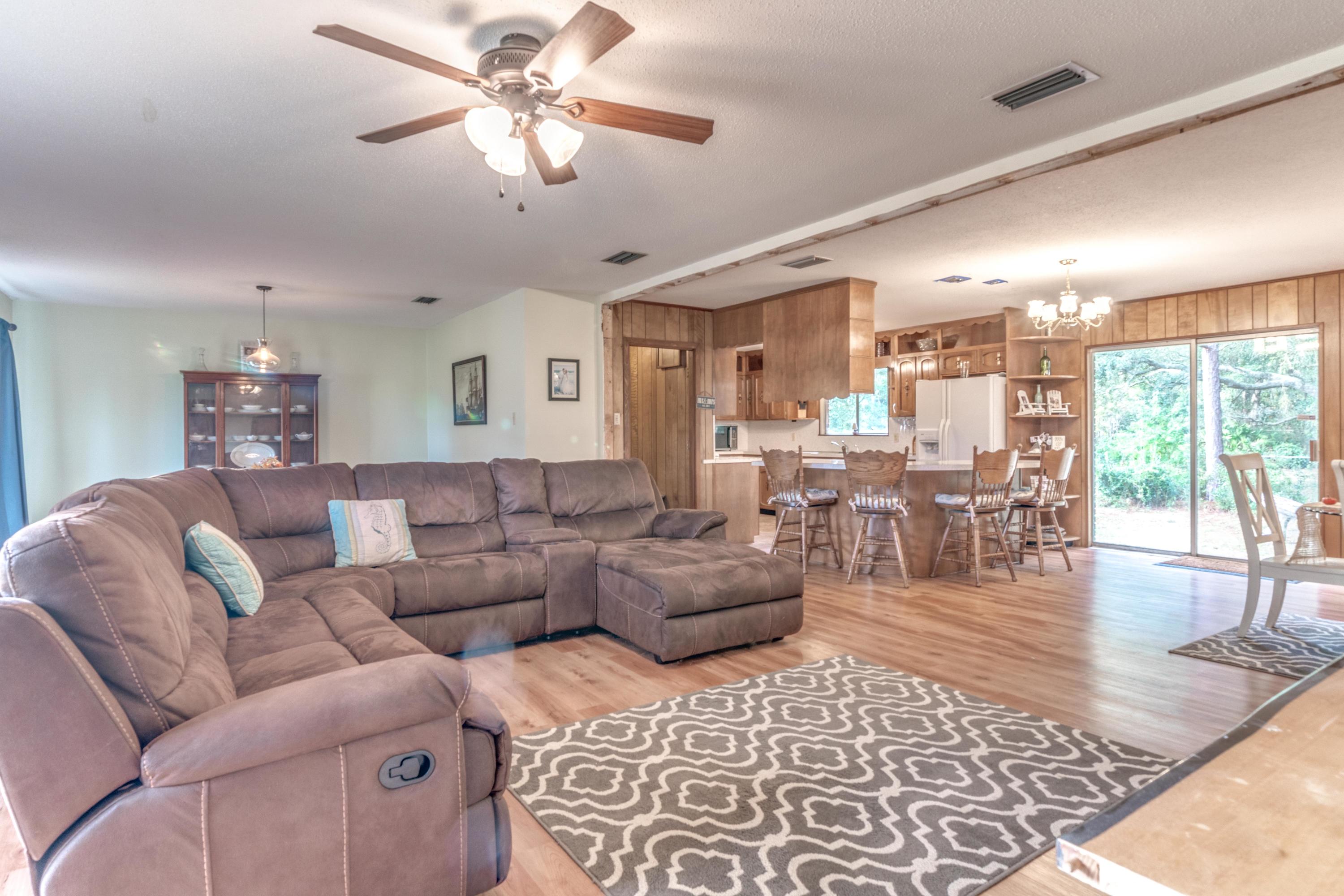 837 Cardinal Street Fort Walton Beach, FL 32547 - Photo 5 of 24 a living room with furniture large window and wooden floor