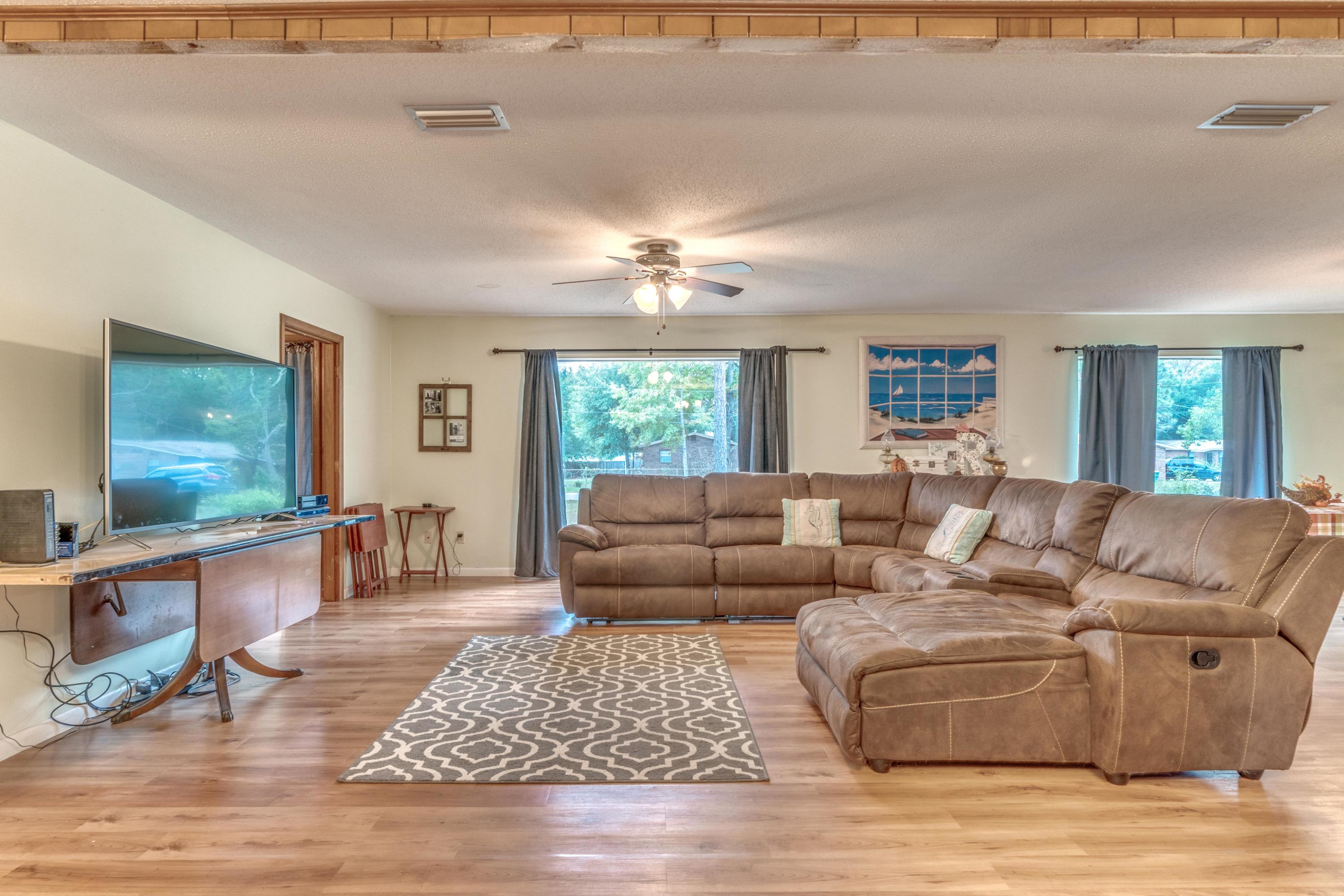 837 Cardinal Street Fort Walton Beach, FL 32547 - Photo 6 of 24 a living room with furniture and a flat screen tv