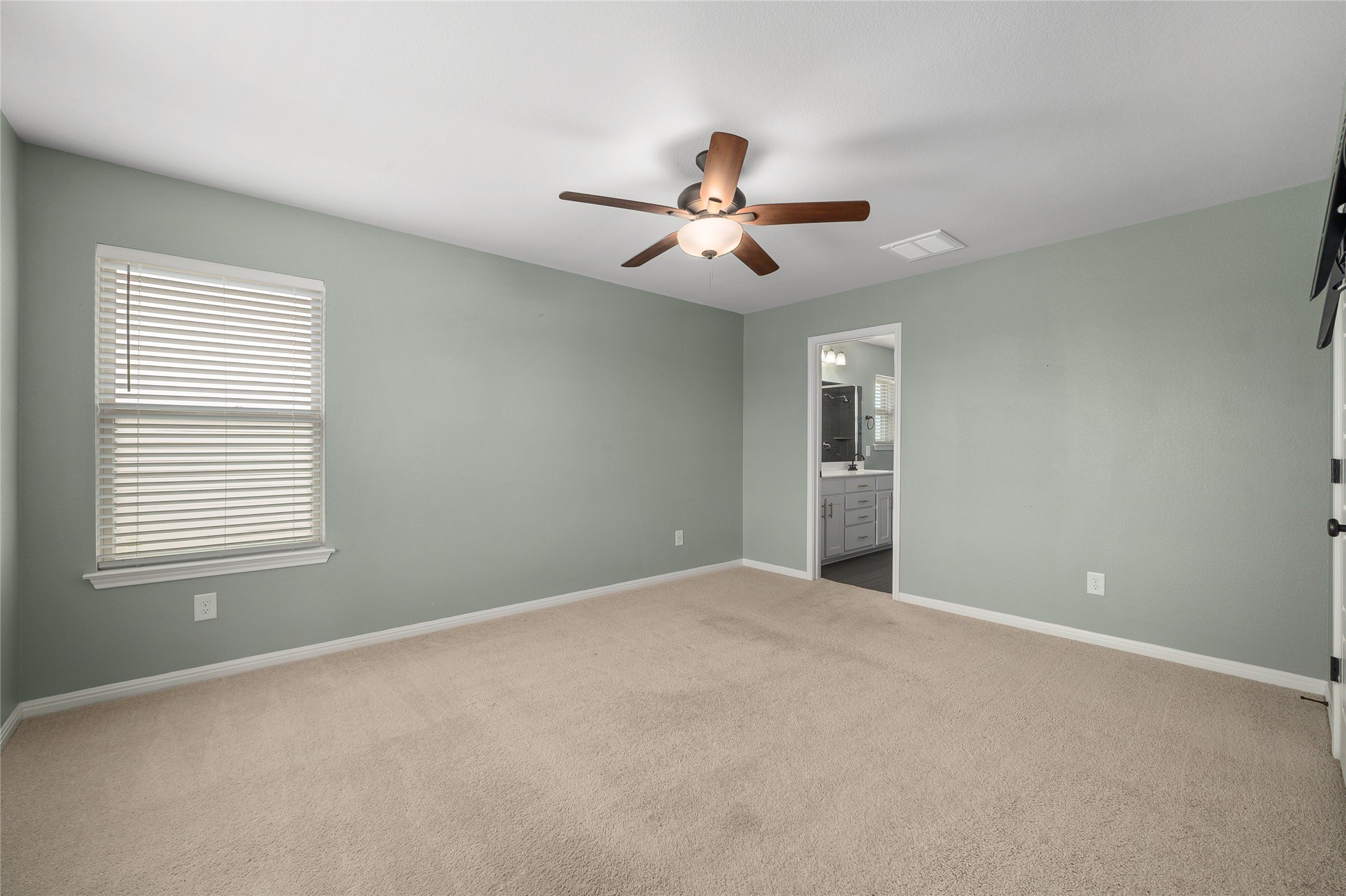 101 Lambert Street Leander, TX 78641 - Photo 16 of 33 A comfortable bedroom with a ceiling fan for year-round climate control.