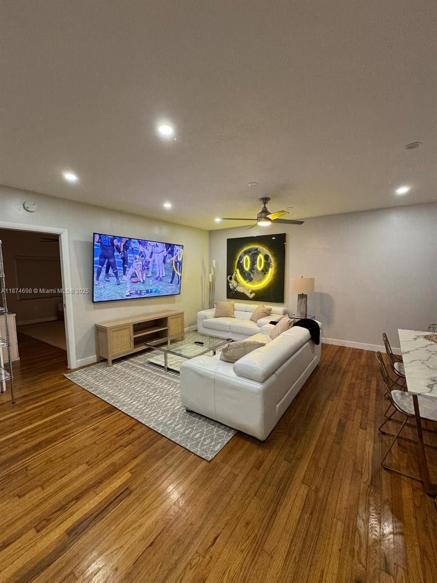 101 Collins Avenue, Unit 3 Miami Beach, FL 33139 - Photo 2 of 4 a living room with furniture and a flat screen tv