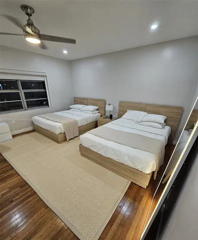 a bedroom with two beds and a stove