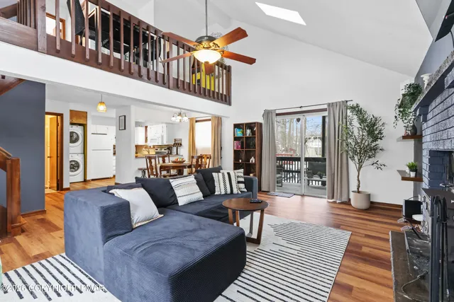 a living room with furniture a rug and a chandelier