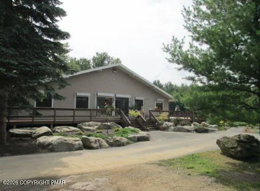 a view of a lake with couches chairs