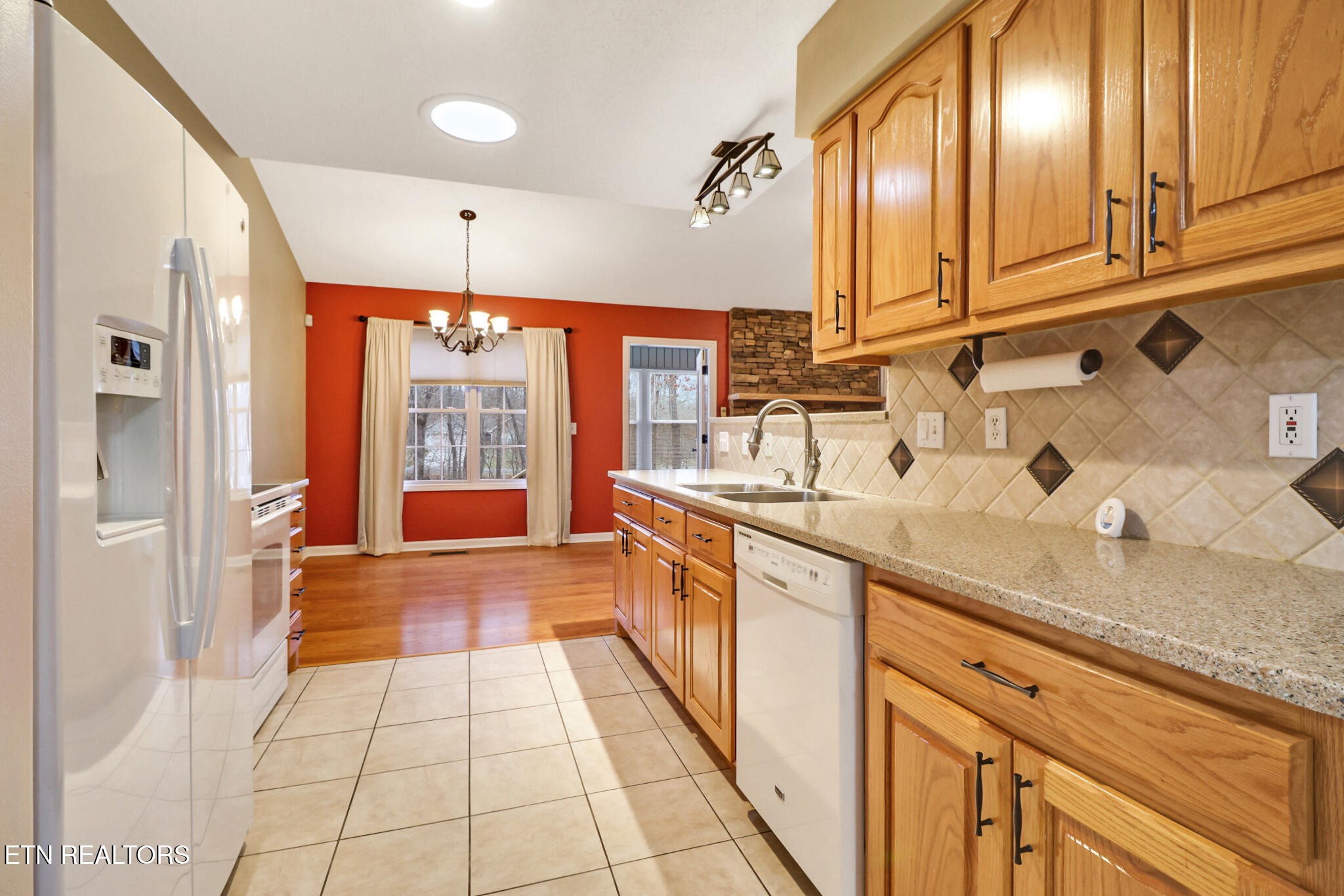 121 St George Drive Crossville, TN 38558 - Photo 19 of 37 a large kitchen with stainless steel appliances granite countertop a sink and cabinets