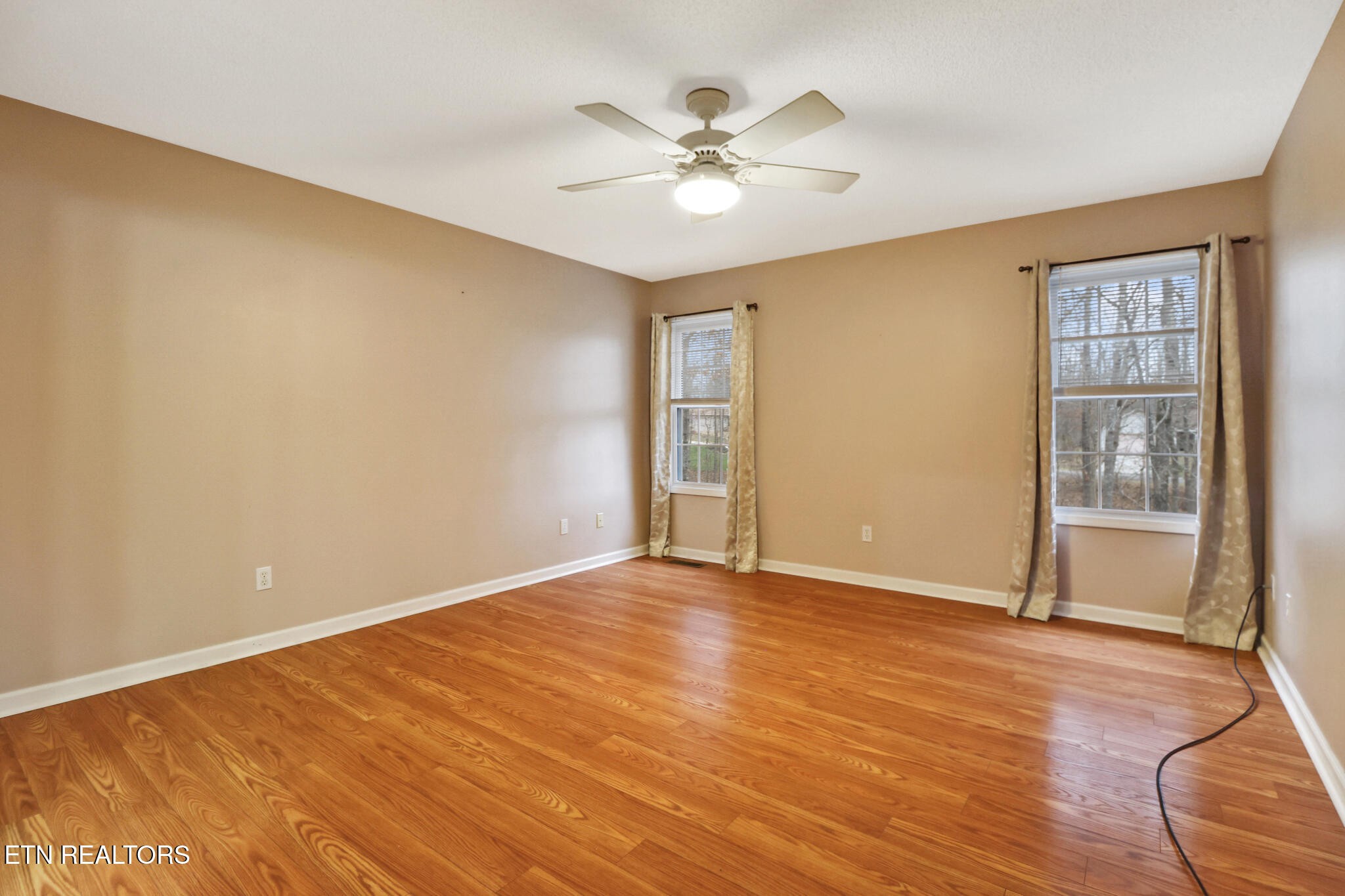 121 St George Drive Crossville, TN 38558 - Photo 22 of 37 an empty room with wooden floor and windows