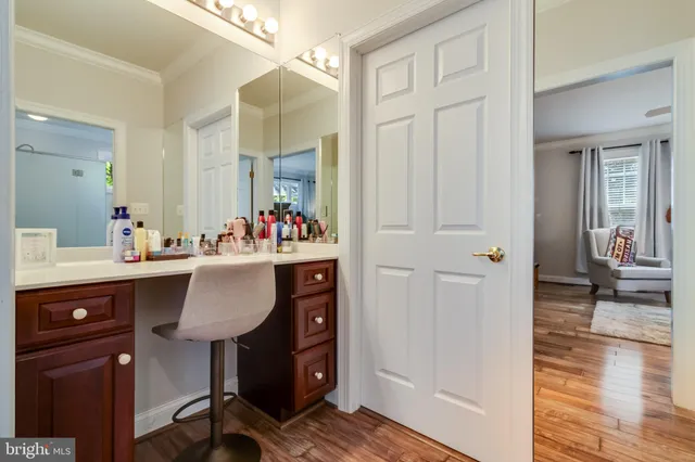 a room with a sink a desk and chair