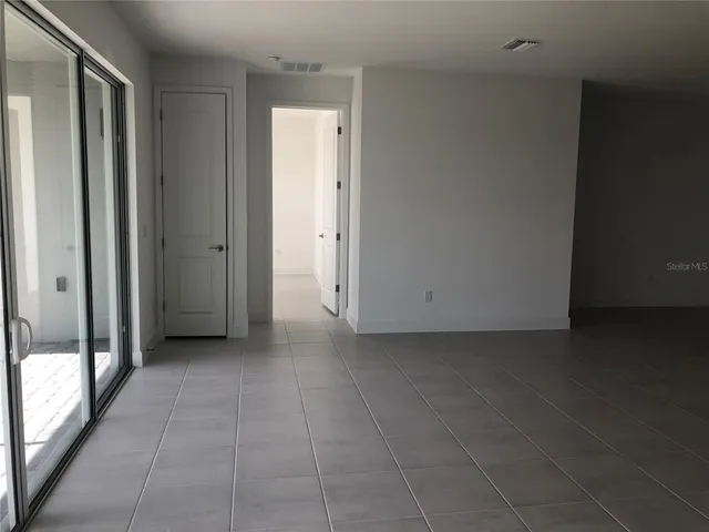 a view of a livingroom with an empty space and a window