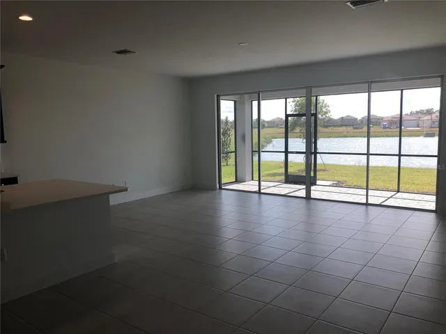 an empty room with large windows