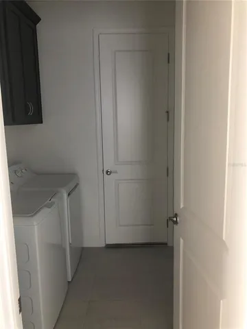 an empty room with closet and mirror